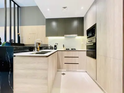 a kitchen with wooden cabinets and a sink at Luxury 1 Bedroom Apartment in Dubai