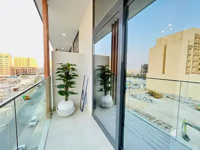 an apartment balcony with two potted plants on it at Luxury 1 Bedroom Apartment in Dubai