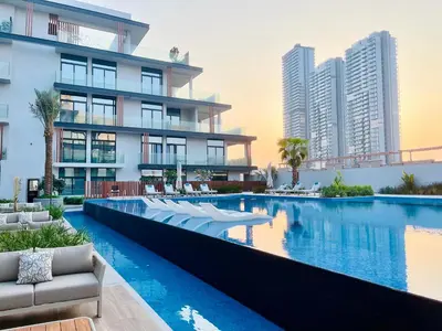 an image of a hotel swimming pool with buildings at Luxury 1 Bedroom Apartment in Dubai