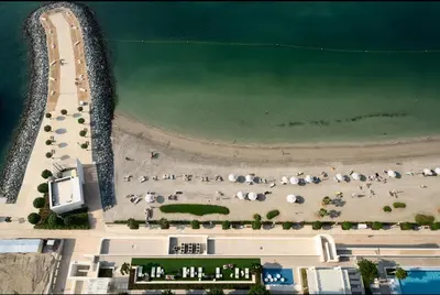 an overhead view of a beach with umbrellas at Palm View - Beach Vista T1 in Dubai