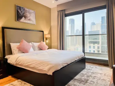 a bedroom with a large bed and a large window at Unforgettable 1BR Mesmerizing Burj Khalifa Views - 17AB02 in Dubai