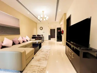 a living room with a couch and a flat screen tv at Unforgettable 1BR Mesmerizing Burj Khalifa Views - 17AB02 in Dubai