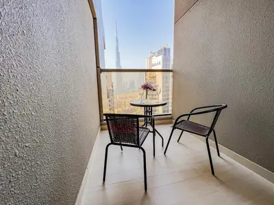 a balcony with a table and two chairs and a window at Unforgettable 1BR Mesmerizing Burj Khalifa Views - 17AB02 in Dubai
