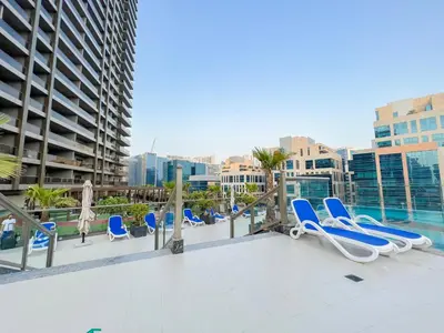 a row of lounge chairs on the roof of a building at Unforgettable 1BR Mesmerizing Burj Khalifa Views - 17AB02 in Dubai