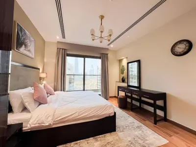 a bedroom with a bed and a desk and a window at Unforgettable 1BR Mesmerizing Burj Khalifa Views - 17AB02 in Dubai