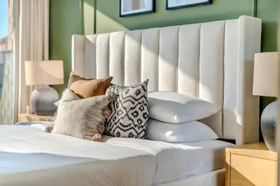 a bedroom with a white bed with pillows at GuestReady - A beautiful home in Jumeirah Village in Dubai