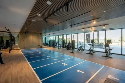 a gym with treadmills and exercise equipment in a building at GuestReady - A beautiful home in Jumeirah Village in Dubai