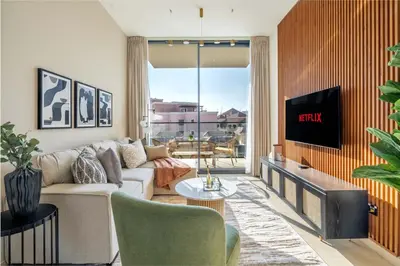 a living room with a couch and a tv at GuestReady - A beautiful home in Jumeirah Village in Dubai