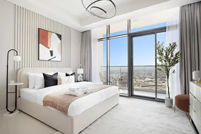 a bedroom with a large white bed and a large window at Silkhaus New Modern studio - Business Bay - O in Dubai