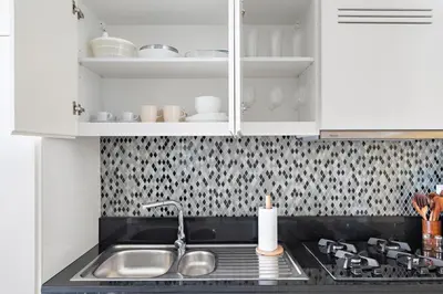 a kitchen with a sink and a stove and cabinets at Silkhaus New Modern studio - Business Bay - O in Dubai