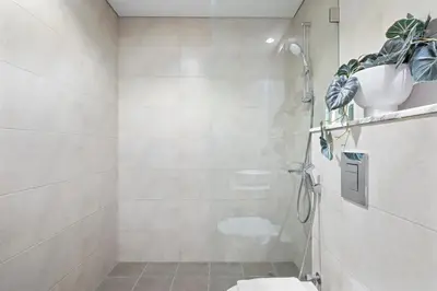 a bathroom with a shower and a toilet in it at Silkhaus New Modern studio - Business Bay - O in Dubai