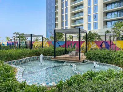 a swimming pool with a fountain in front of a building at Silkhaus New Modern studio - Business Bay - O in Dubai
