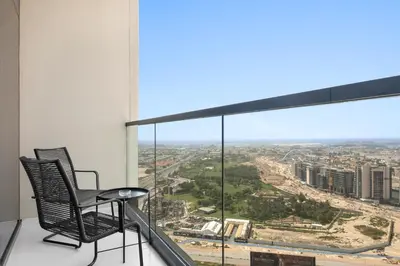a balcony with two chairs and a view of a city at Silkhaus New Modern studio - Business Bay - O in Dubai