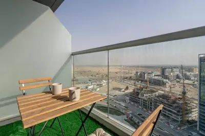 a balcony with a bench and a view of a city at GuestReady - Bella Rose residence in Dubai in Dubai