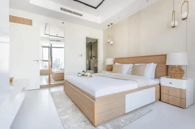 a bedroom with a large bed and white walls at Frank Porter - Paramount in Dubai