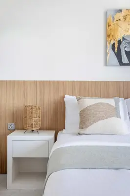a bedroom with a bed and a nightstand with a white bed at Frank Porter - Paramount in Dubai