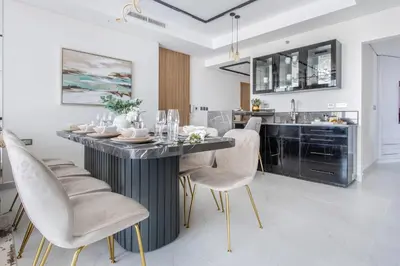 a kitchen and dining room with a table and chairs at Frank Porter - Paramount in Dubai
