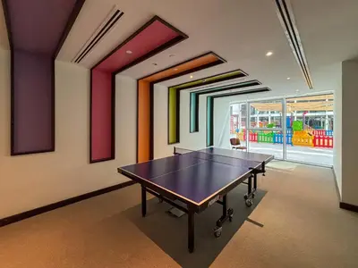 a dining room with a ping pong table in it at Frank Porter - Park Gate Residences 1 in Dubai