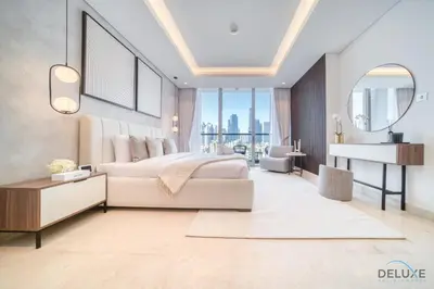 a bedroom with a bed and a desk and a piano at Burj Khalifa Views! Promo on 1BR at Sterling House by Deluxe Holiday Homes in Dubai