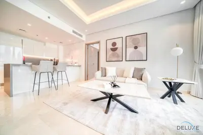 a living room with a couch and a table at Burj Khalifa Views! Promo on 1BR at Sterling House by Deluxe Holiday Homes in Dubai