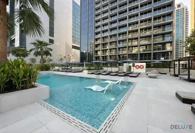 a swimming pool in the middle of a building at Burj Khalifa Views! Promo on 1BR at Sterling House by Deluxe Holiday Homes in Dubai