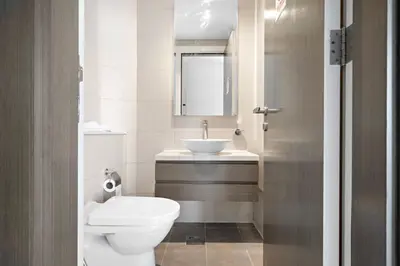 a bathroom with a white toilet and a sink at ALiving Charming 1BR I Canal Views I DAMAC Maison Prive B- 2101 in Dubai