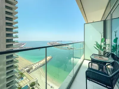 a balcony with a view of the beach and ocean at Fully Furnished - 1 BR - Palm View with Beach Access in Dubai