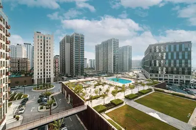 an aerial view of a city with tall buildings at Beautiful 1 Bedroom Dubai Hills with Pool View in Dubai