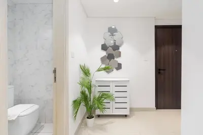 a bathroom with a toilet and a plant in it at Modern 1-bedroom apartment in family-friendly residence with Swimming Pool, Gym & Free Parking. in Dubai
