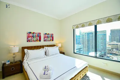 a bedroom with a bed and a large window at Luxury Escapes - Budget 1BR Apt in Marina - Near Tram & Metro -Time Place Tower in Dubai