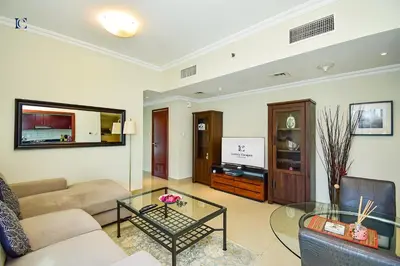 a living room with a couch and a glass table at Luxury Escapes - Budget 1BR Apt in Marina - Near Tram & Metro -Time Place Tower in Dubai