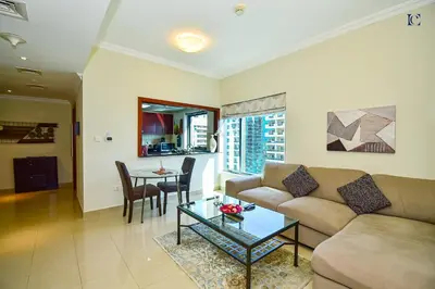 a living room with a couch and a table at Luxury Escapes - Budget 1BR Apt in Marina - Near Tram & Metro -Time Place Tower in Dubai