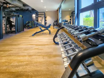 a gym with treadmills and elliptical machines at Sea View 3 BD apartment in La Mer near the beach in Dubai