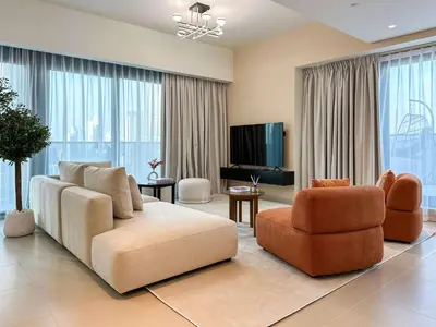 a living room with a couch and a chair at Unique Burj Khalifa View 3BR Condo On Top Floor in Dubai