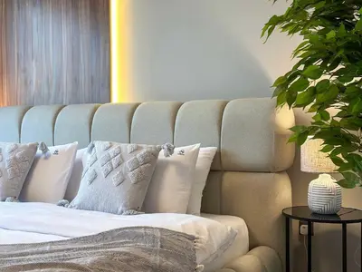 a bedroom with a bed with white pillows at Unique Burj Khalifa View 3BR Condo On Top Floor in Dubai