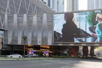 a large billboard in front of a building at Frank Porter - Reva Residence in Dubai