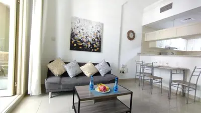 a living room with a couch and a table at Marina View Manchester tower in Dubai