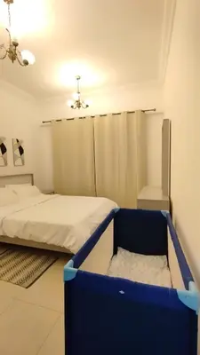 a room with two beds and a ceiling at Marina View Manchester tower in Dubai