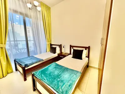 a hotel room with two beds and a window at 1o mins to metro. New. Stylish in Dubai