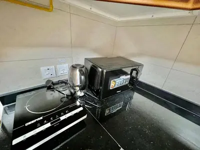 a toaster oven sitting on a counter in a kitchen at 1o mins to metro. New. Stylish in Dubai