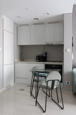 a kitchen with a table and two chairs in it at Quiet 1BR with river view in Dubai