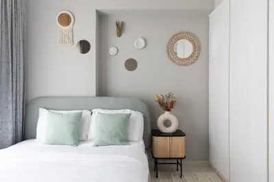 a bedroom with a bed and a vase on a table at Quiet 1BR with river view in Dubai