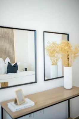 a room with a mirror and a table with flowers at The Legend Fashionable 2 Bed Apartment in Downtown in Dubai
