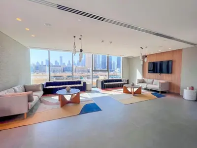 a large living room with couches and a tv at The Legend Fashionable 2 Bed Apartment in Downtown in Dubai