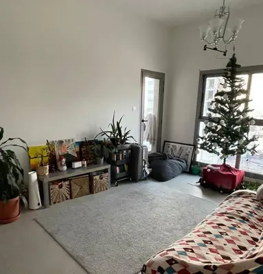 a living room with a christmas tree in it at Burj Khalifa view/ Cozy apartment in Dubai