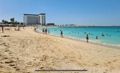 a group of people in the water at a beach at Burj Khalifa view/ Cozy apartment in Dubai