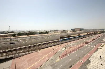 an overhead view of a train station with trains at Aura Azizi - Downtown Jabel Ali by Golden Casa in Dubai