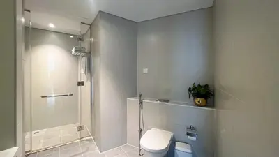 a bathroom with a shower and a toilet in it at Keyrock Living - Studio with Burj Khalifa View in Dubai