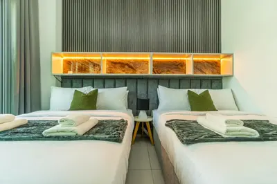 two beds sitting next to each other in a room at Unforgettable Canal & Sea View in Dubai Marina in Dubai