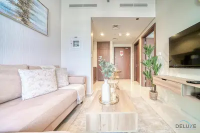 a living room with a couch and a table at Hot Offer Modern 1BR with Scenic Water Canal Views by Deluxe Holiday Homes in Dubai